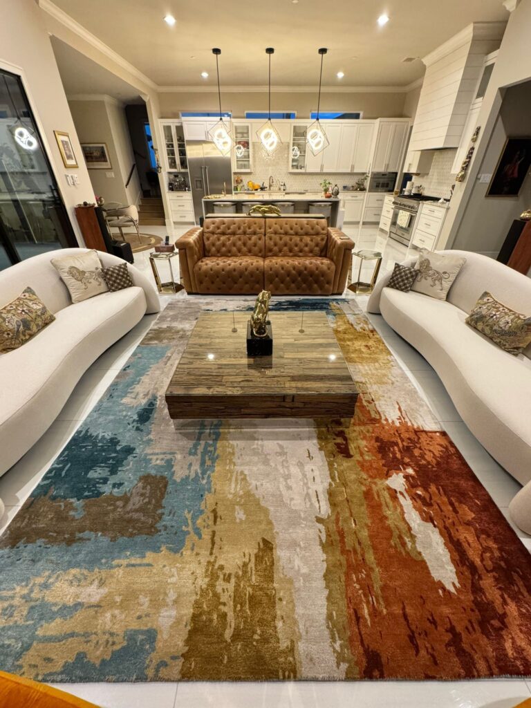 Luxury modern living room with designer furniture and open-concept kitchen.